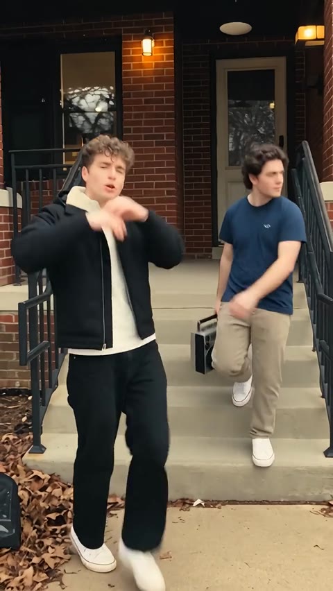 Two men stepping down porch stairs at the opening of Boombox Rap AI