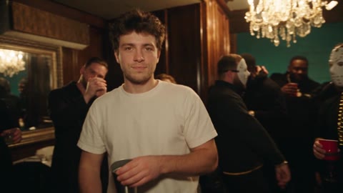 Burning Bridges AI opening with the white-shirted man standing in a chandelier-lit crowd