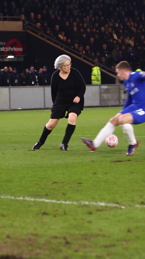Ozil Goal AI attacker facing a blue-shirted defender with the ball between them